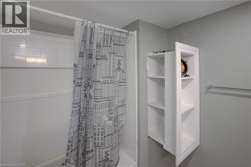 White subway tile shower surround with a built-in recessed shelving unit - 53 Prosperity Drive, Kitchener, ON - Indoor Photo Showing Bathroom