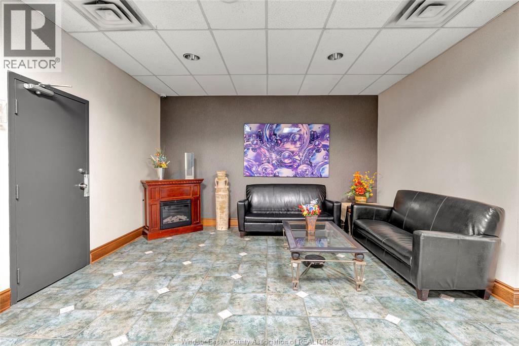 540 Ouellette Unit# 7B, Windsor, ON - Indoor Photo Showing Living Room With Fireplace