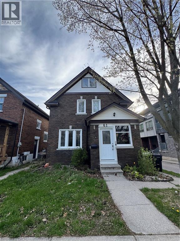 Brick facade residence featuring a white entry door, multiple pane windows, a covered porch, and an asphalt shingle roof - 61 Waterloo Drive, Kitchener, ON - Outdoor With Facade