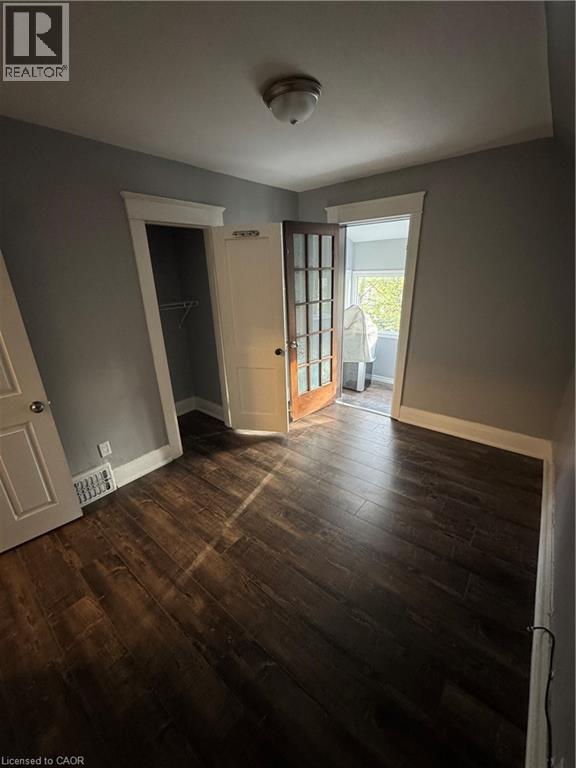 Room featuring dark wood-finish flooring, light gray walls, and white trim - 61 Waterloo Drive, Kitchener, ON - Indoor Photo Showing Other Room