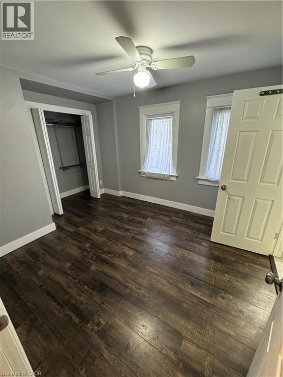 Interior room featuring wood-finish flooring, light gray wall paint, and white trim - 61 Waterloo Drive, Kitchener, ON - Indoor Photo Showing Other Room