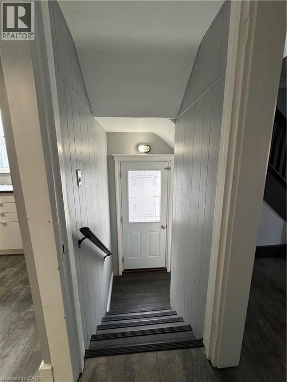 Stairwell featuring dark wood-finish treads and a matte black handrail - 61 Waterloo Drive, Kitchener, ON - Indoor Photo Showing Other Room