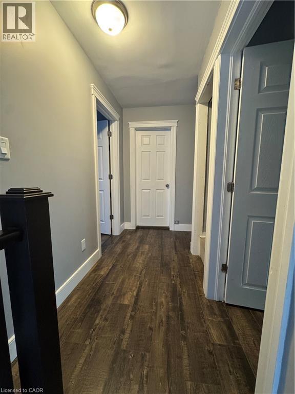 Hallway featuring durable wood-finish flooring, light gray wall paint, and white trim - 61 Waterloo Drive, Kitchener, ON - Indoor Photo Showing Other Room