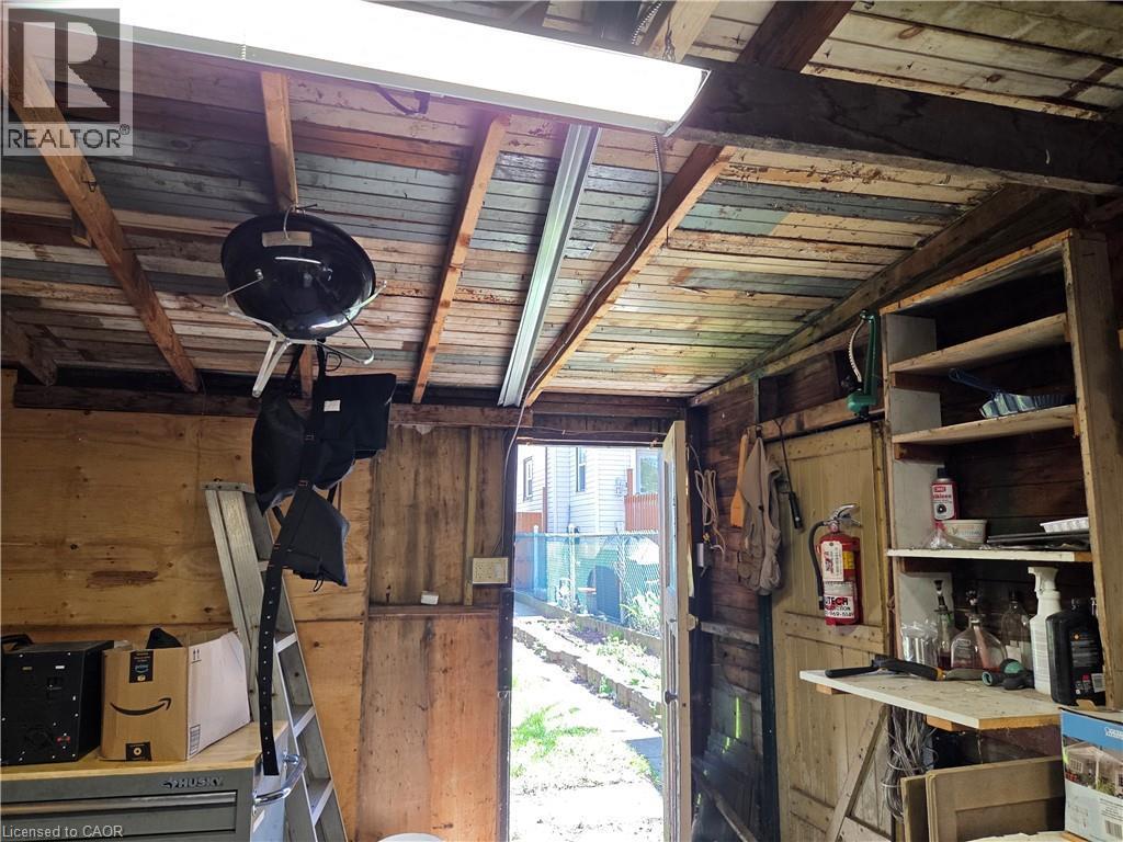 Utility shed with exposed wood framing, built-in shelving, and plywood wall finishes - 125 Cavell Avenue, Hamilton, ON - Indoor