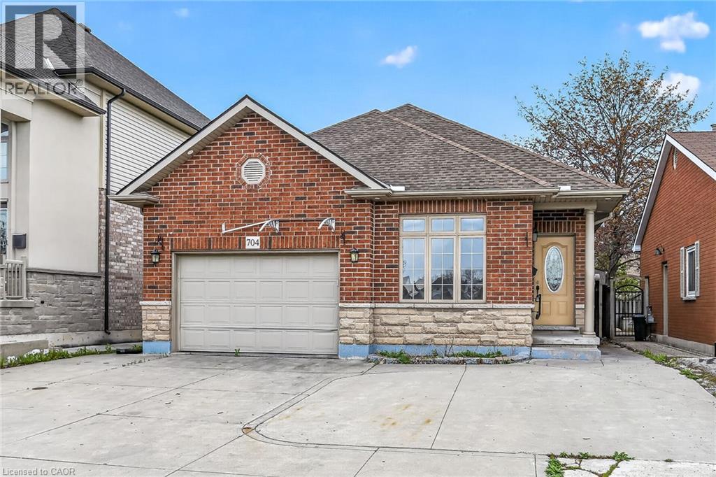 Brick exterior with stone accents and a gabled roofline - 704 Stone Church Road E, Hamilton, ON - Outdoor
