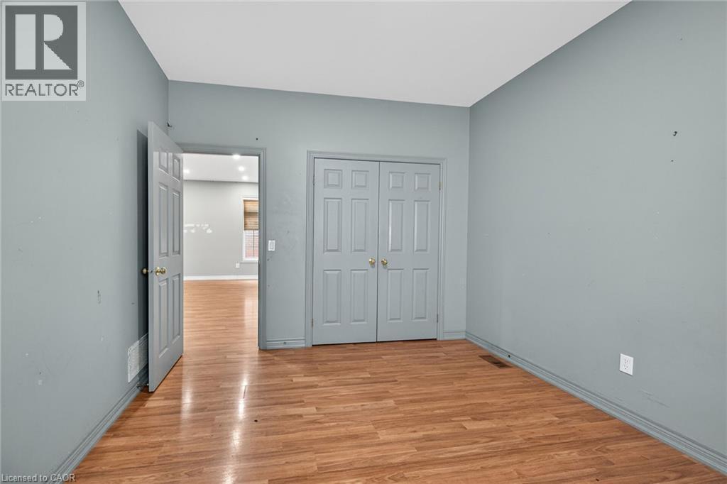 Open-concept interior featuring wood-finish flooring, recessed lighting, and white baseboards - 704 Stone Church Road E, Hamilton, ON - Indoor Photo Showing Other Room