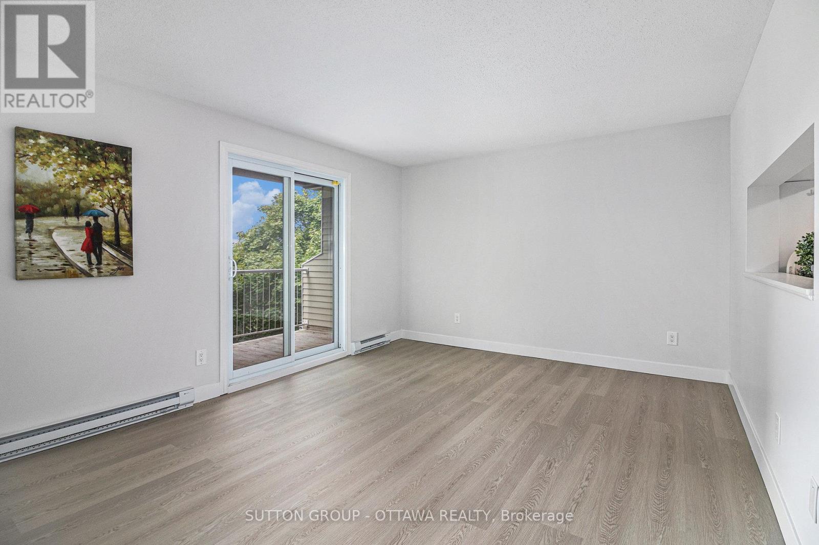 Living/Dining room with patio door to balcony - 314 - 270 Brittany Drive, Ottawa, ON - Indoor Photo Showing Other Room