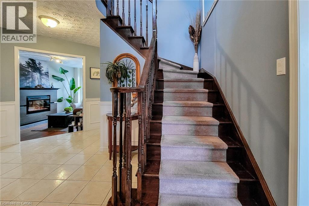 Wooden staircase with carpeted treads and carved balusters - 146 Locheed Drive, Hamilton, ON - Indoor Photo Showing Other Room