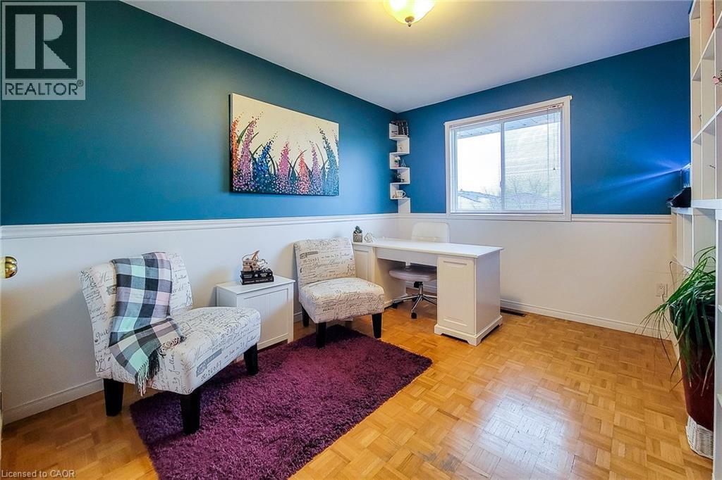Room with wood-finish flooring and a partial wall of built-in shelving - 146 Locheed Drive, Hamilton, ON - Indoor