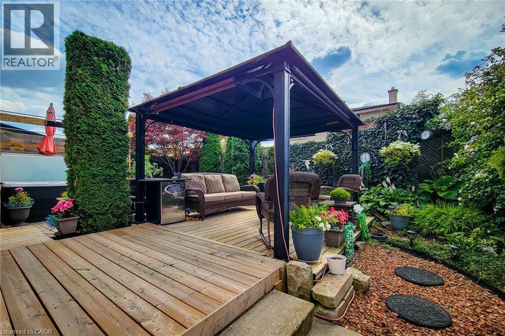 Expansive wood-finish deck featuring a dark-framed gazebo - 146 Locheed Drive, Hamilton, ON - Outdoor With Deck Patio Veranda