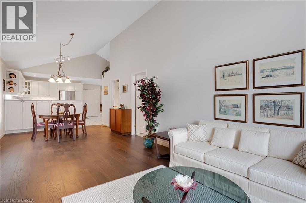 Open-concept living space featuring wood-finish flooring, vaulted ceilings, and recessed lighting - 422 Powerline Road Unit# 10, Brantford, ON - Indoor Photo Showing Living Room