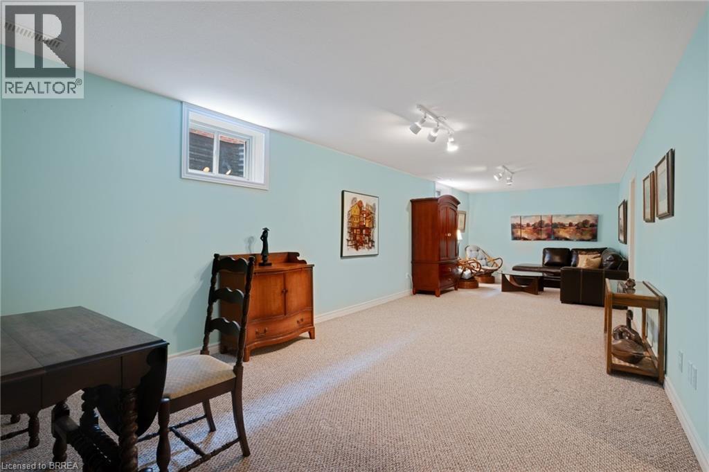 Spacious room featuring light blue walls, white trim, and neutral-toned carpet flooring - 422 Powerline Road Unit# 10, Brantford, ON - Indoor