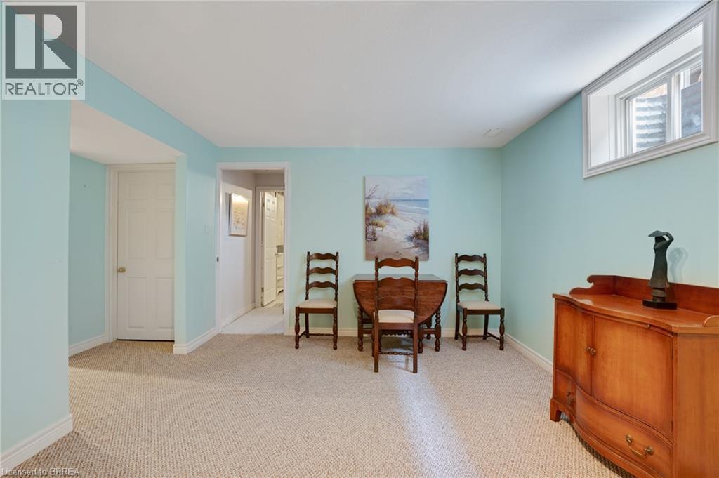 Carpeted room featuring light blue walls, white trim, and a high-set window - 422 Powerline Road Unit# 10, Brantford, ON - Indoor