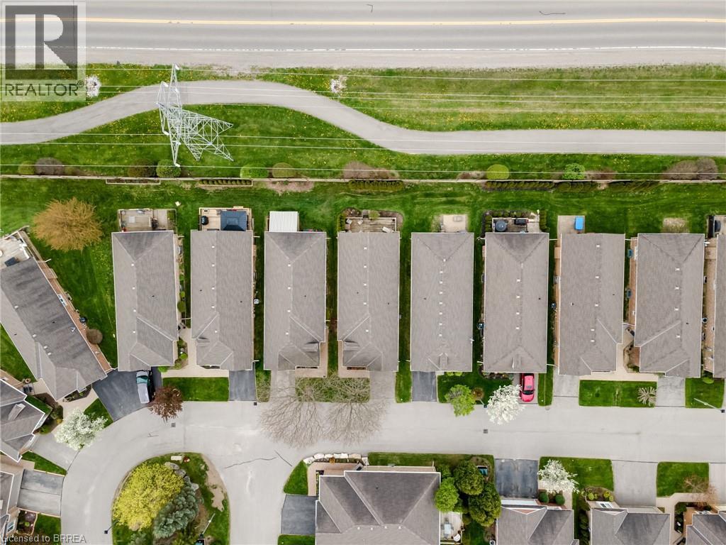 Aerial view of a residential community featuring multiple homes with gray shingle roofs - 422 Powerline Road Unit# 10, Brantford, ON - Outdoor With View