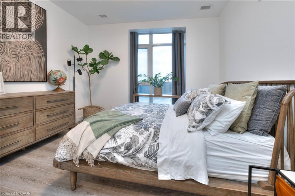 Bedroom featuring dark wood-type flooring - 50 Grand Avenue S Unit# 602, Cambridge, ON - Indoor Photo Showing Bedroom