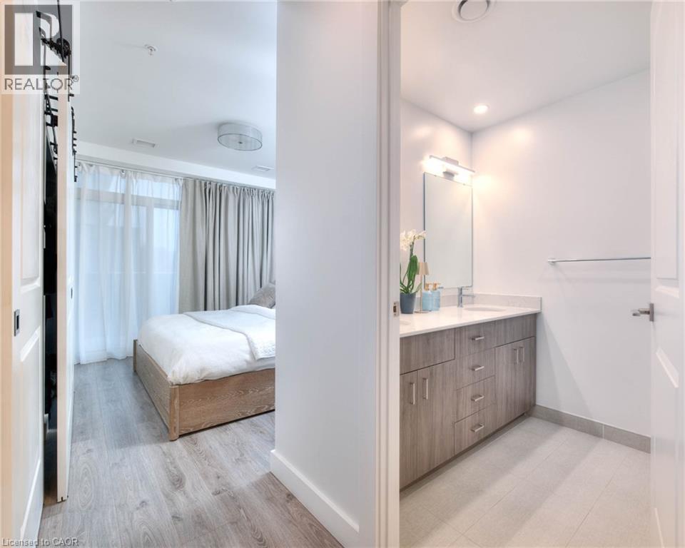 Ensuite bathroom featuring double vanity, light wood finished floors, and recessed lighting - 50 Grand Avenue S Unit# 602, Cambridge, ON - Indoor Photo Showing Bathroom