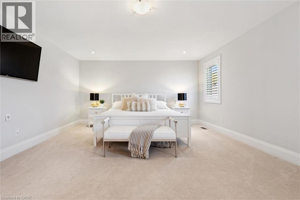 Carpeted bedroom featuring recessed lighting, a ceiling-mounted fixture, and a window with plantation shutters - 72 Elmbank Trail, Kitchener, ON - Indoor Photo Showing Bedroom