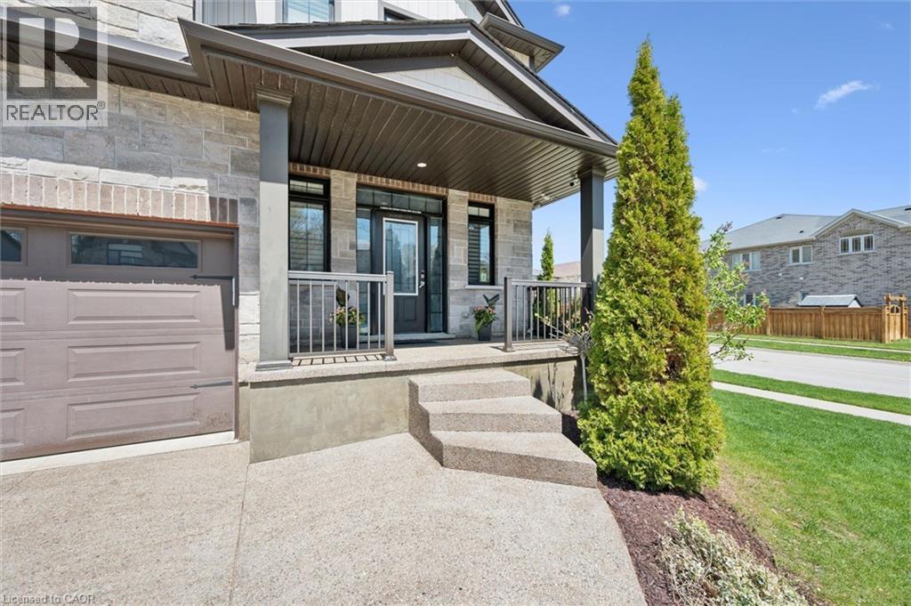 Covered front porch with stone and brick facade - 72 Elmbank Trail, Kitchener, ON - Outdoor With Deck Patio Veranda