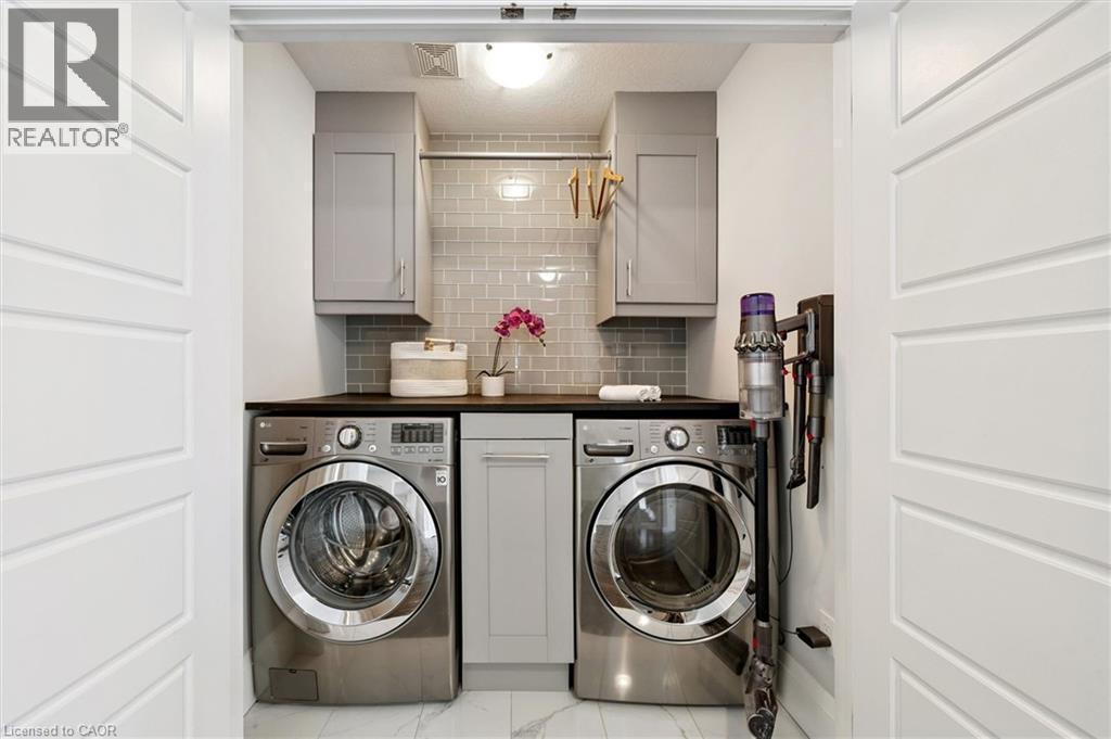 Dedicated laundry area featuring front-loading washer and dryer units - 72 Elmbank Trail, Kitchener, ON - Indoor Photo Showing Laundry Room