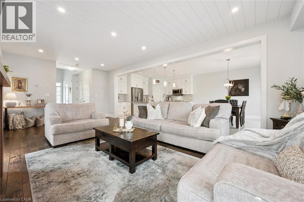 Expansive living area featuring rich wood-finish flooring and a distinctive shiplap ceiling with recessed lighting - 72 Elmbank Trail, Kitchener, ON - Indoor Photo Showing Living Room