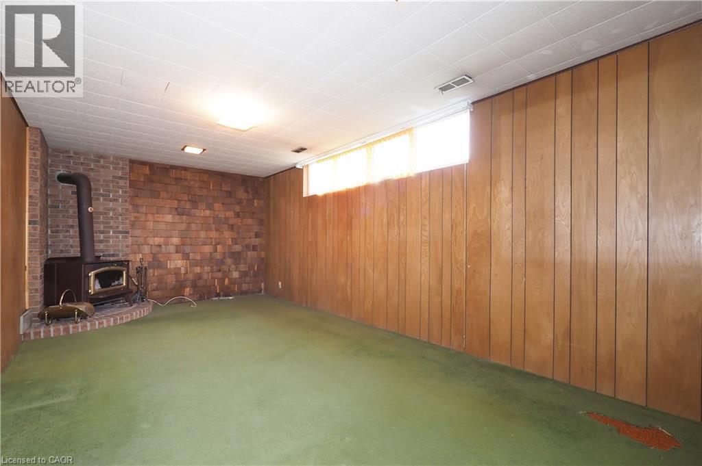 Basement recreation room featuring airtight wood stove - 76 Cloverdale Crescent, Kitchener, ON - Indoor