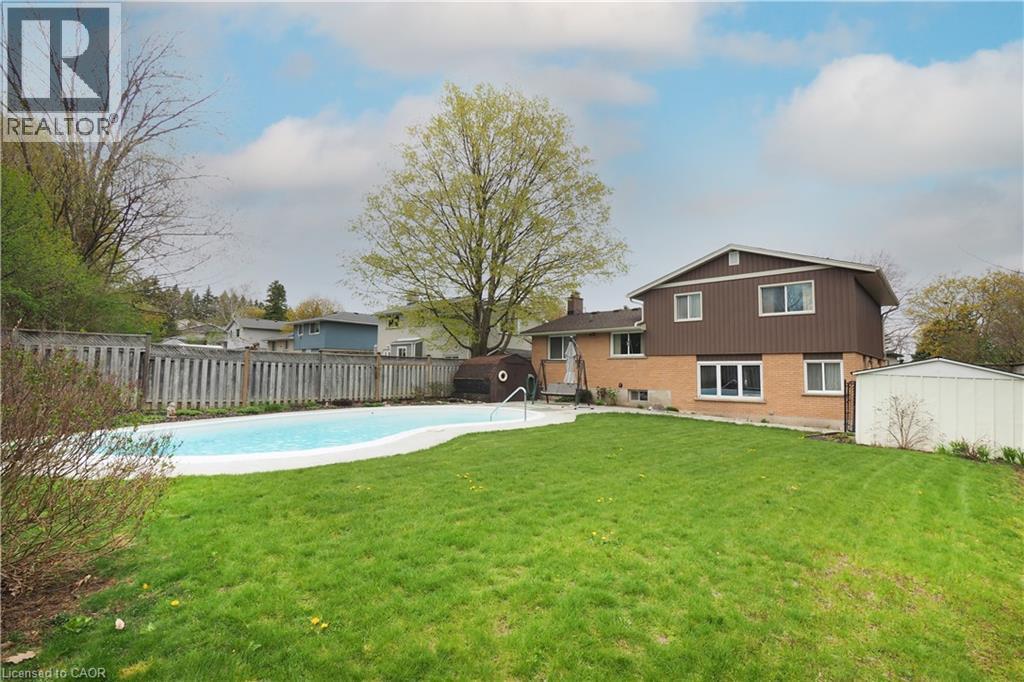 Private backyard with view of house and inground gunite pool - 76 Cloverdale Crescent, Kitchener, ON - Outdoor With Backyard