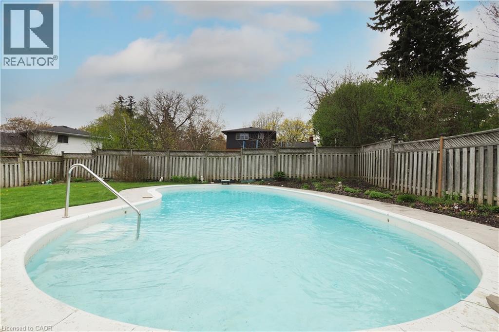 Luxurious gunite pool framed by stamped concrete patio - 76 Cloverdale Crescent, Kitchener, ON - Outdoor With In Ground Pool With Backyard