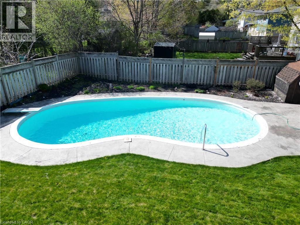 Kidney shaped durable gunite pool - 76 Cloverdale Crescent, Kitchener, ON - Outdoor With In Ground Pool With Backyard