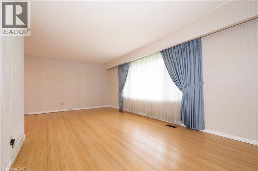 Living room featuring large window, included window treatments & refinished flooring - 76 Cloverdale Crescent, Kitchener, ON - Indoor Photo Showing Other Room