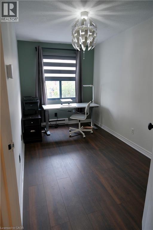 Room featuring wood-finish flooring, a contemporary ceiling light fixture, and a window with blinds and drapes - 175 Hunter Street E Unit# 301, Hamilton, ON - Indoor Photo Showing Office