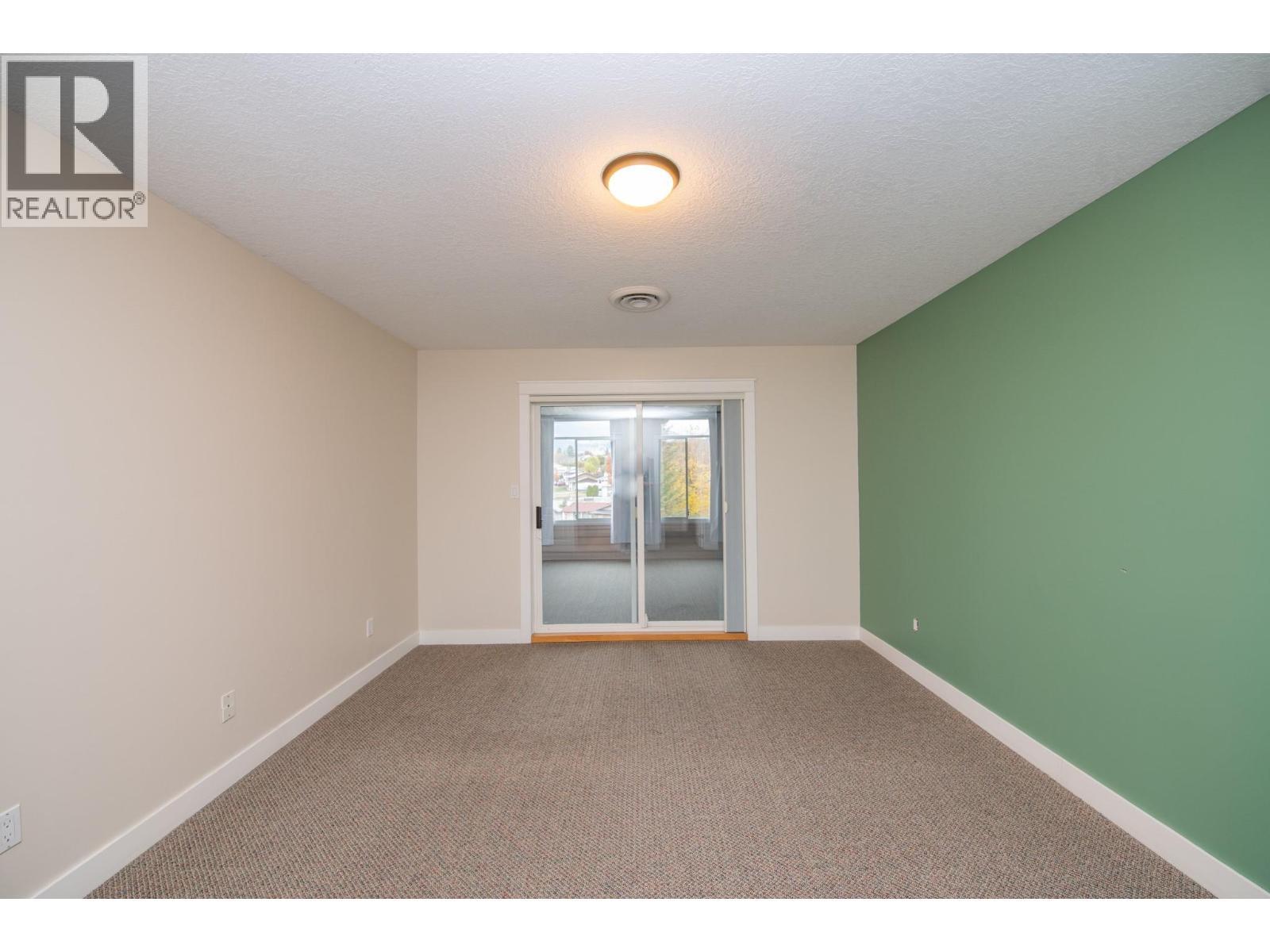 Patio doors lead to enclosed patio/deck area - 3929 22 Avenue Unit# 309, Vernon, BC - Indoor Photo Showing Other Room