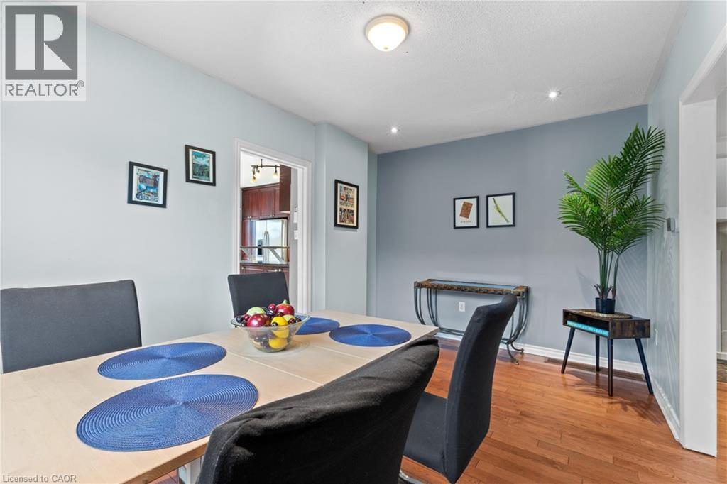 Dining area featuring wood-finish flooring, recessed lighting, a modern ceiling light fixture, and a doorway opening to an additional room - 204 Beach Boulevard, Hamilton, ON - Indoor Photo Showing Dining Room