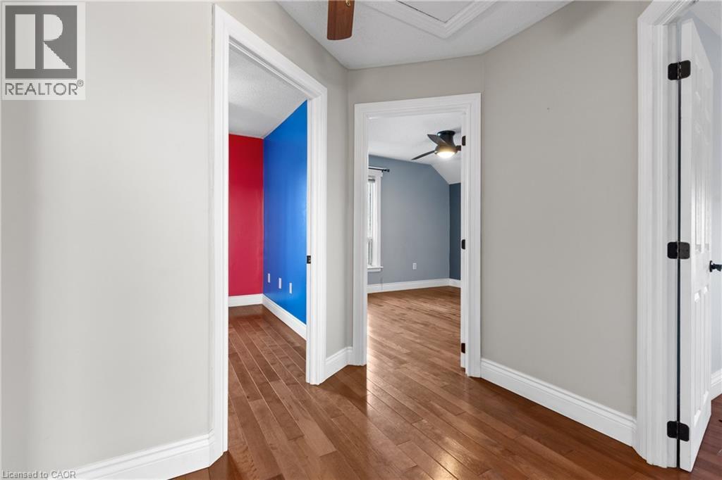 Hallway with wood-finish flooring, light gray wall paint, and white trim - 204 Beach Boulevard, Hamilton, ON - Indoor Photo Showing Other Room