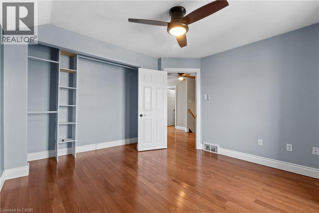 Bedroom featuring wood-finish flooring and light blue walls - 204 Beach Boulevard, Hamilton, ON - Indoor Photo Showing Other Room