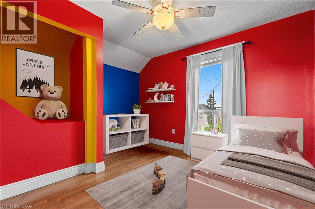 Room featuring wood-finish flooring and a ceiling fan (Virtually Staged) - 204 Beach Boulevard, Hamilton, ON - Indoor