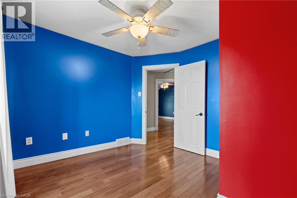Room featuring wood-finish flooring, white baseboards, and a ceiling fan with light fixture - 204 Beach Boulevard, Hamilton, ON - Indoor Photo Showing Other Room