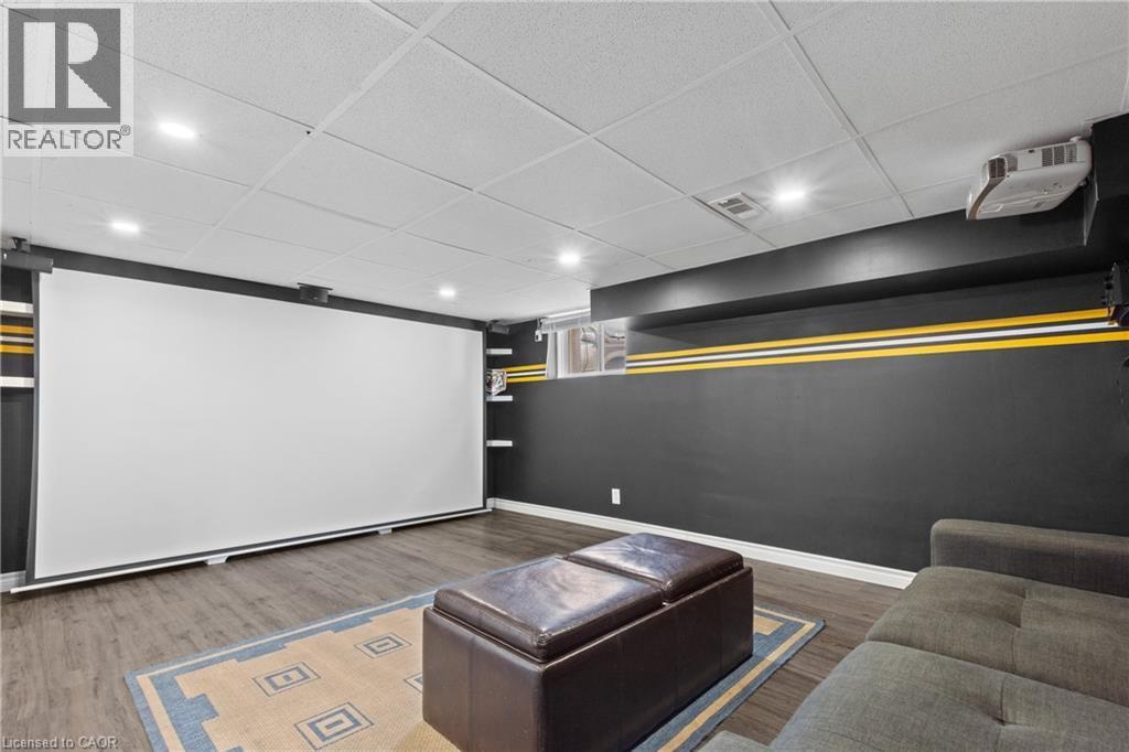 Entertainment room featuring a large projection screen, recessed lighting, and wood-finish flooring - 204 Beach Boulevard, Hamilton, ON - Indoor