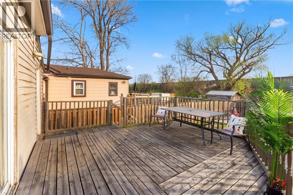 Expansive wood-finish deck with perimeter railing and a small built-in shed - 204 Beach Boulevard, Hamilton, ON - Outdoor With Deck Patio Veranda With Exterior