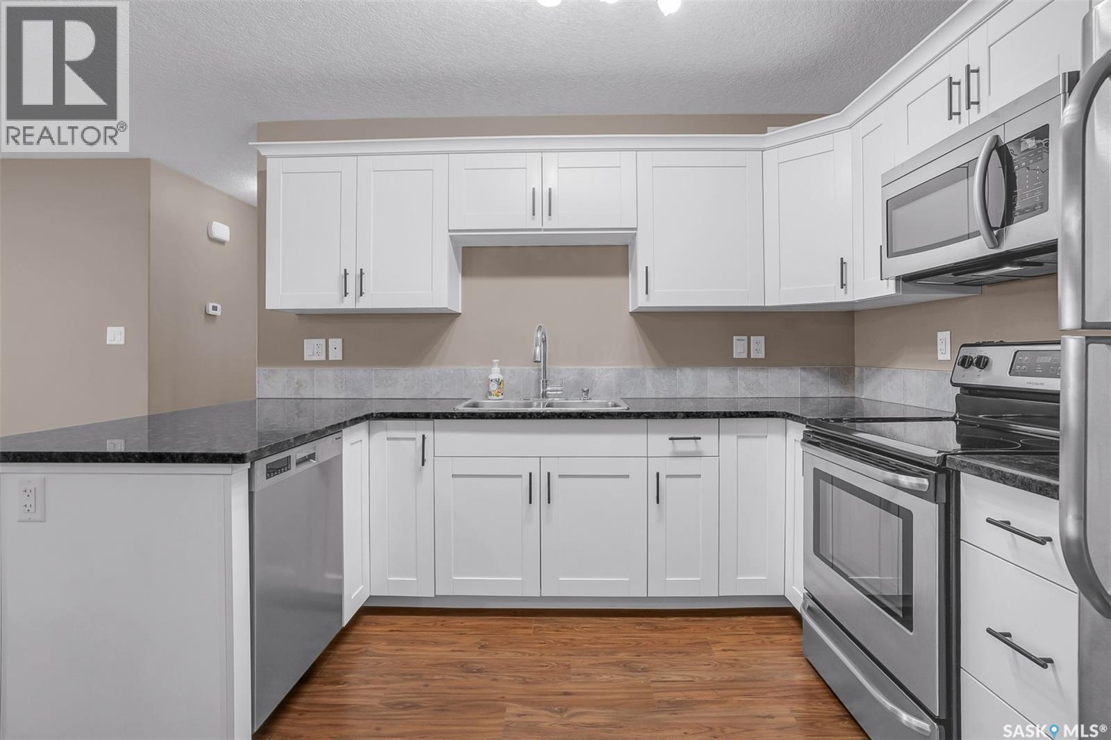 128 125 Willis Crescent, Saskatoon, SK - Indoor Photo Showing Kitchen With Double Sink