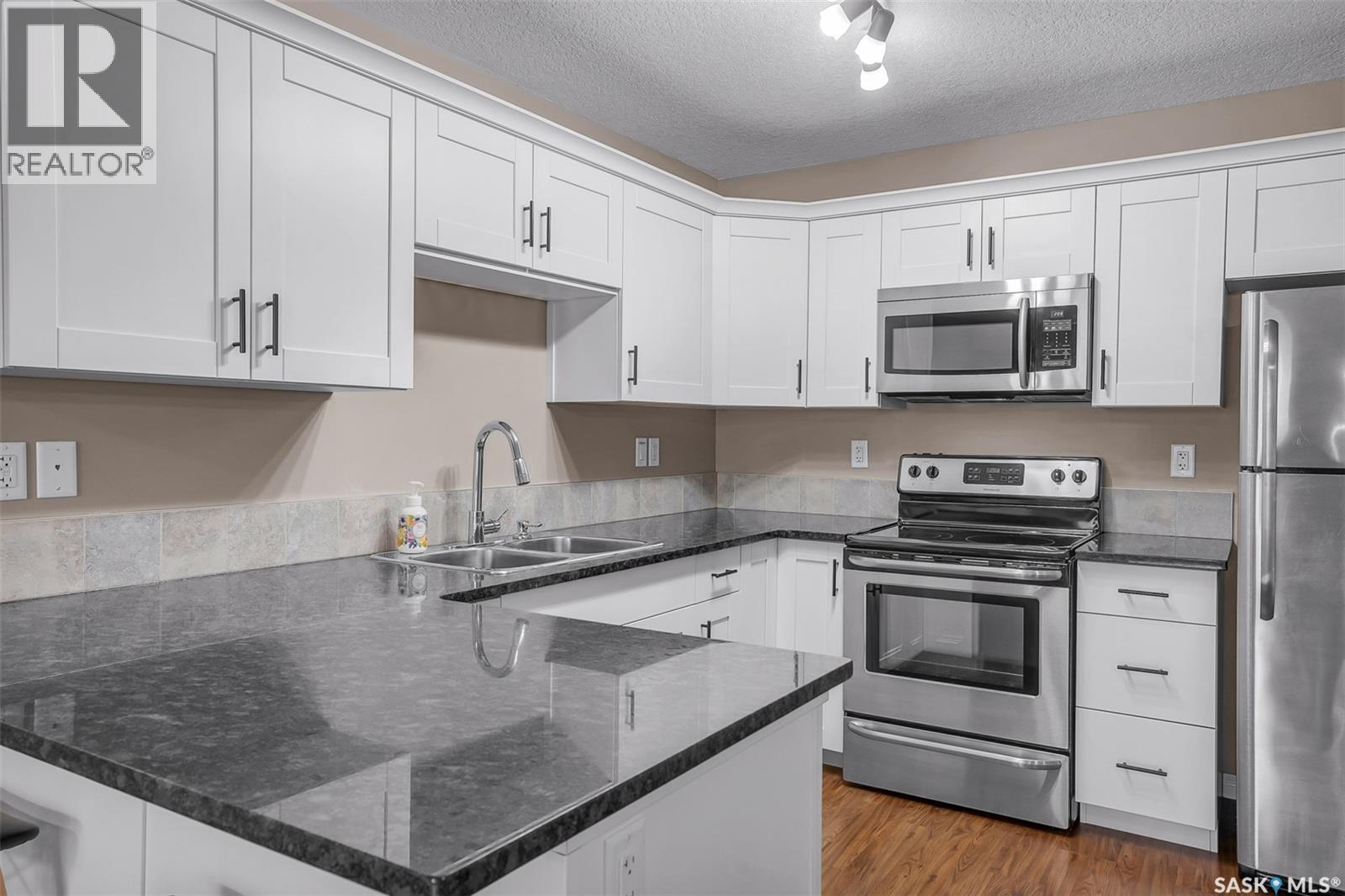 128 125 Willis Crescent, Saskatoon, SK - Indoor Photo Showing Kitchen With Stainless Steel Kitchen With Double Sink
