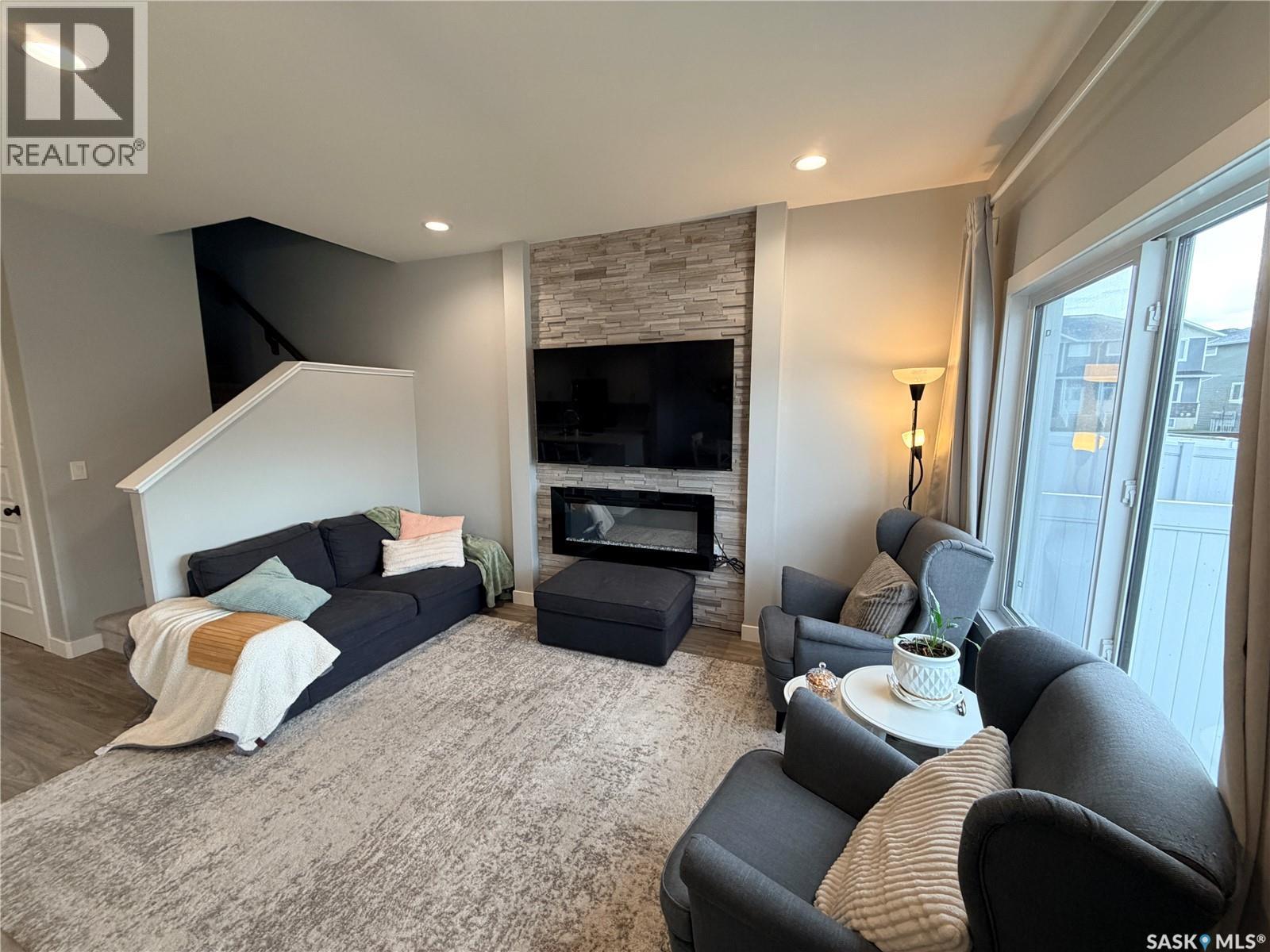 22 1003 Evergreen Boulevard, Saskatoon, SK - Indoor Photo Showing Living Room With Fireplace