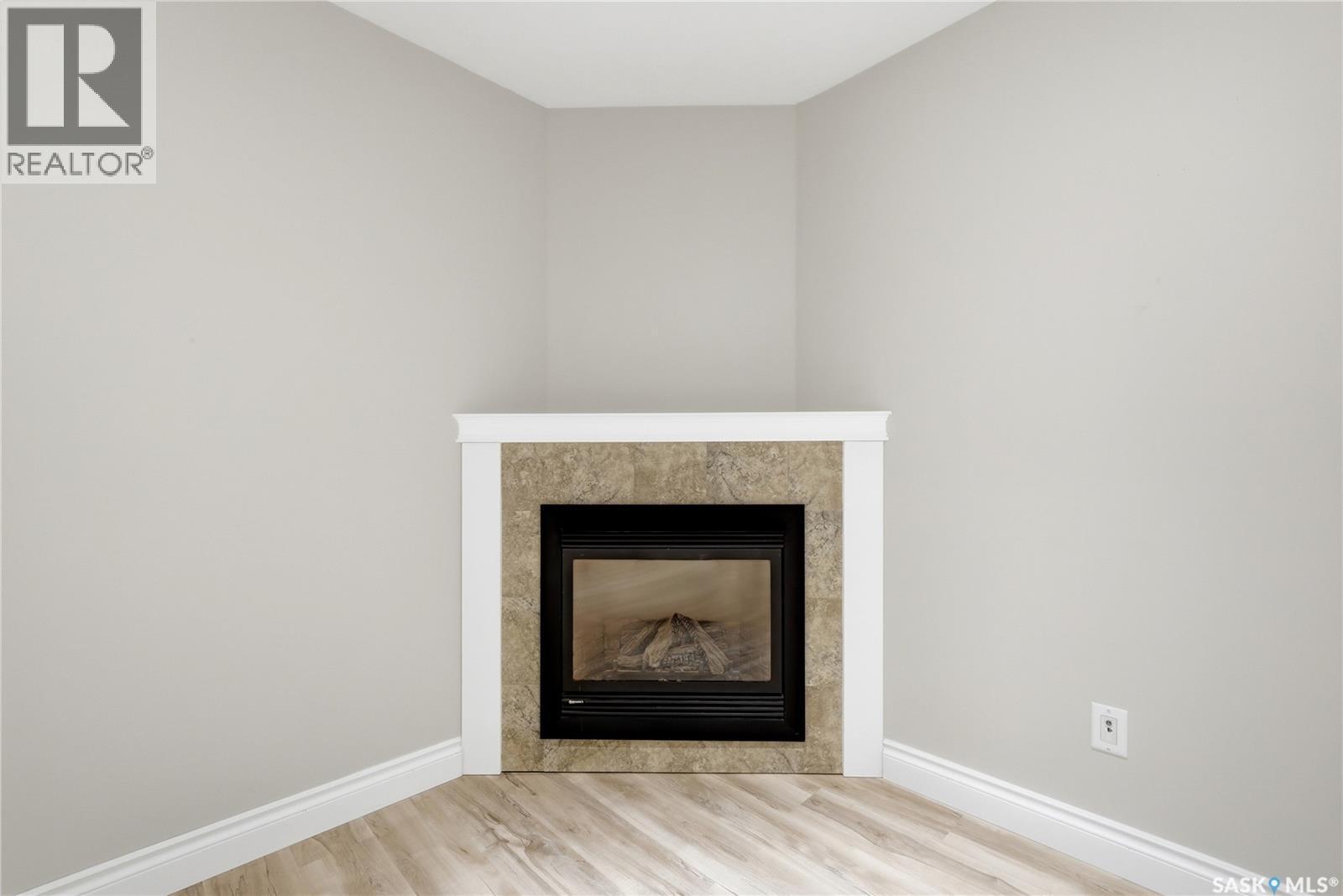 9382 Wascana Mews, Regina, SK - Indoor Photo Showing Other Room With Fireplace