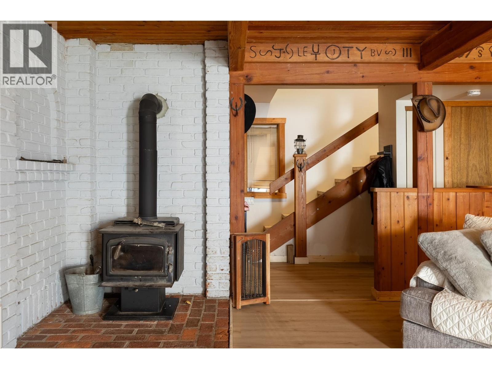 Cozy wood stove for those chilly evenings - 4644 97 Highway, Westwold, BC - Indoor Photo Showing Other Room With Fireplace