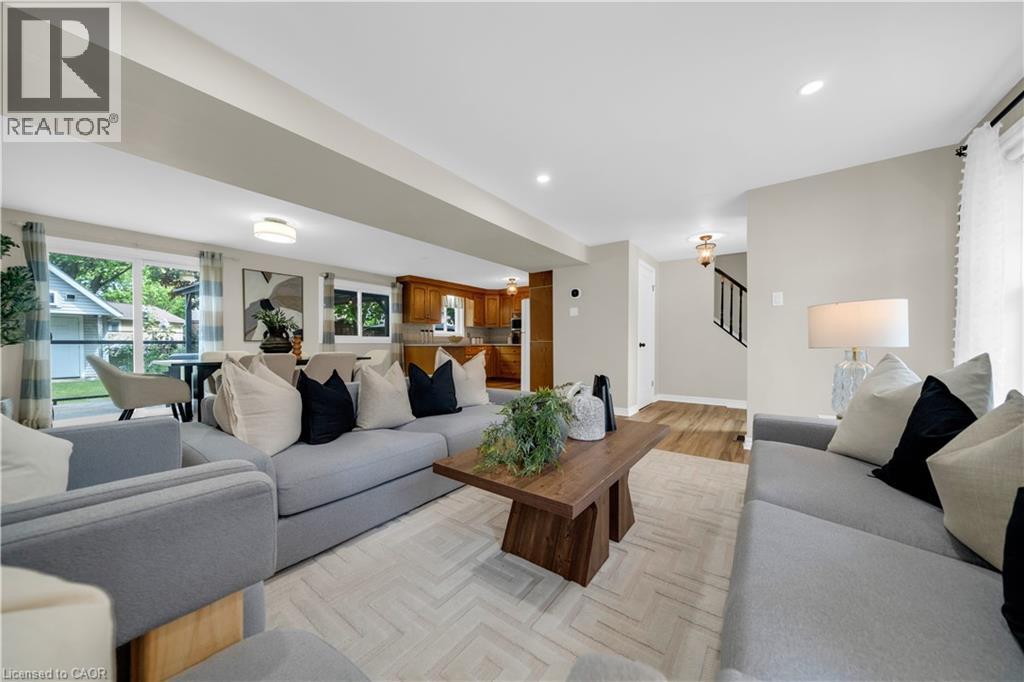 Open-concept living space featuring light-toned walls, recessed lighting, and herringbone-patterned area rug - 26 Peachtree Crescent, Cambridge, ON - Indoor Photo Showing Living Room