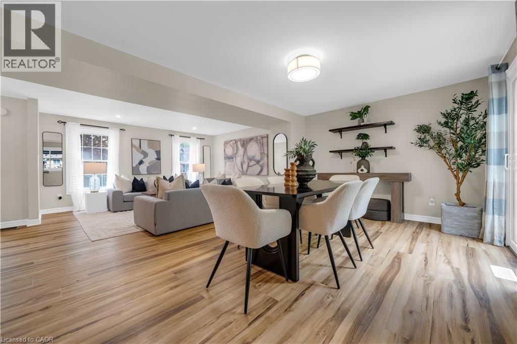 Spacious open-concept living and dining areas featuring wood-finish flooring, recessed lighting, and large windows - 26 Peachtree Crescent, Cambridge, ON - Indoor Photo Showing Other Room
