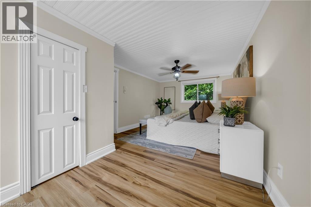 Wood-finish flooring throughout, complemented by a white beadboard ceiling and crisp white trim - 26 Peachtree Crescent, Cambridge, ON - Indoor Photo Showing Other Room