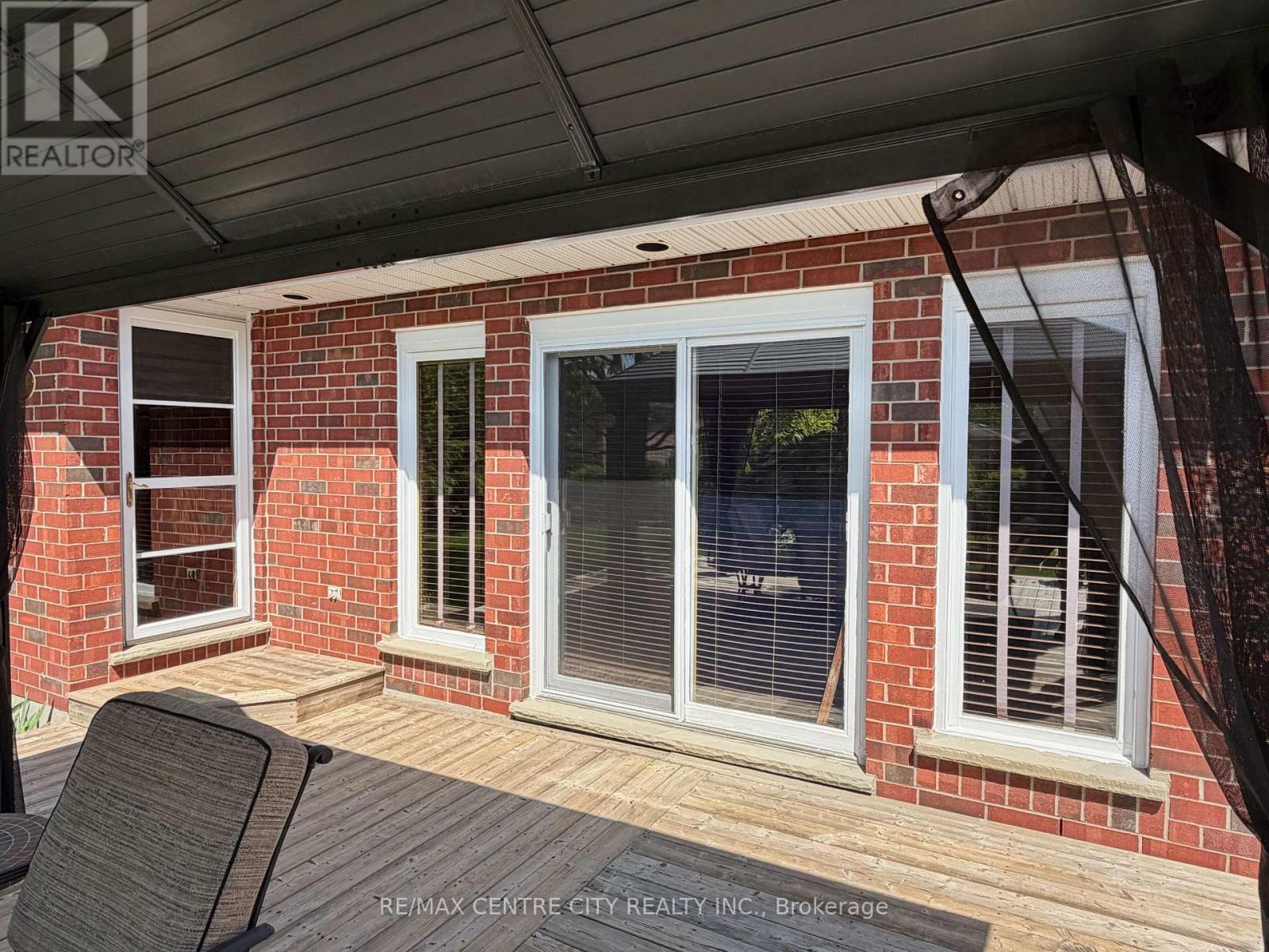 REAR EXTERIOR DOORS FROM EATING AREA AND FAMILY RM - 31 Cavanaugh Crescent, St. Thomas, ON - Outdoor With Deck Patio Veranda With Exterior