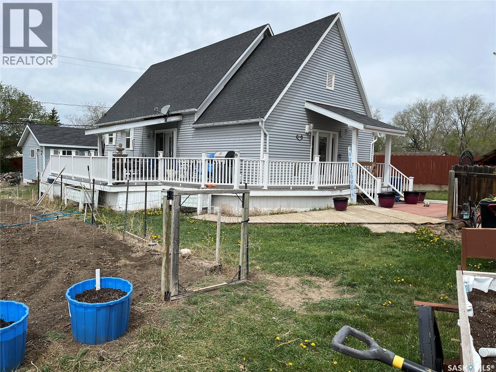 158 Municipal Road, Coronach, SK - Outdoor With Above Ground Pool With Deck Patio Veranda
