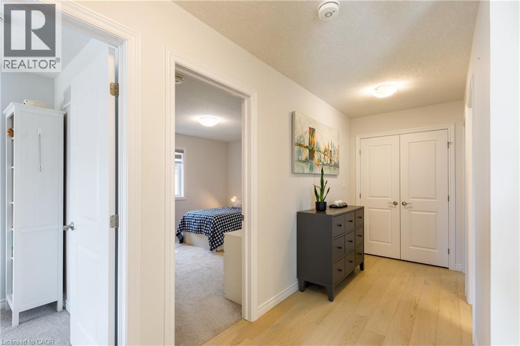 Interior hallway featuring wood-finish flooring, white trim, and light wall paint - 581 Doonwoods Crescent, Kitchener, ON - Indoor Photo Showing Other Room