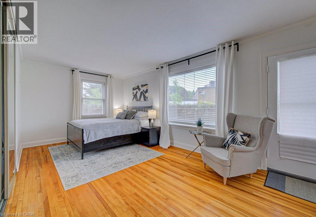 Bright room featuring wood-finish flooring, white walls, and crown molding - 128 Pollock Avenue, Cambridge, ON - Indoor Photo Showing Bedroom